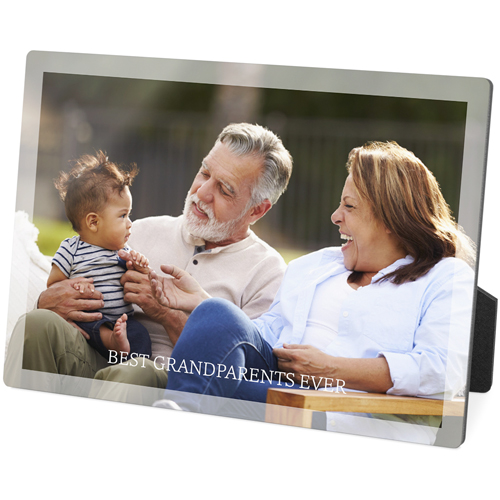 A transparent plaque frame with a photo of a man, woman, and baby on it